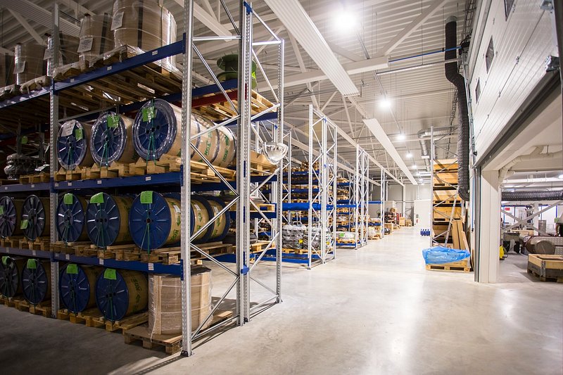 Warehouse racking holding palletised, tagged stock staged under hold.